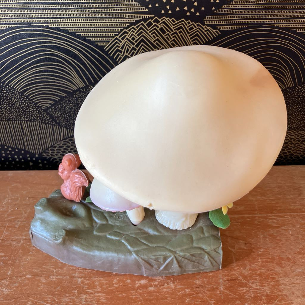 Decorative mushroom figure with a textured base on a wooden surface