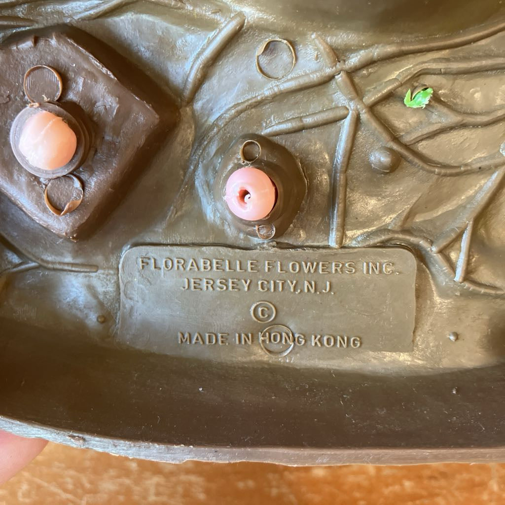Plastic blow mold with 'Florabelle Flowers Inc.' branding and 'Made in Hong Kong' text.