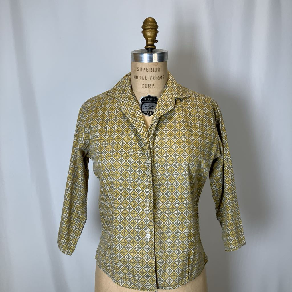 Vintage shirt on a mannequin against a plain background