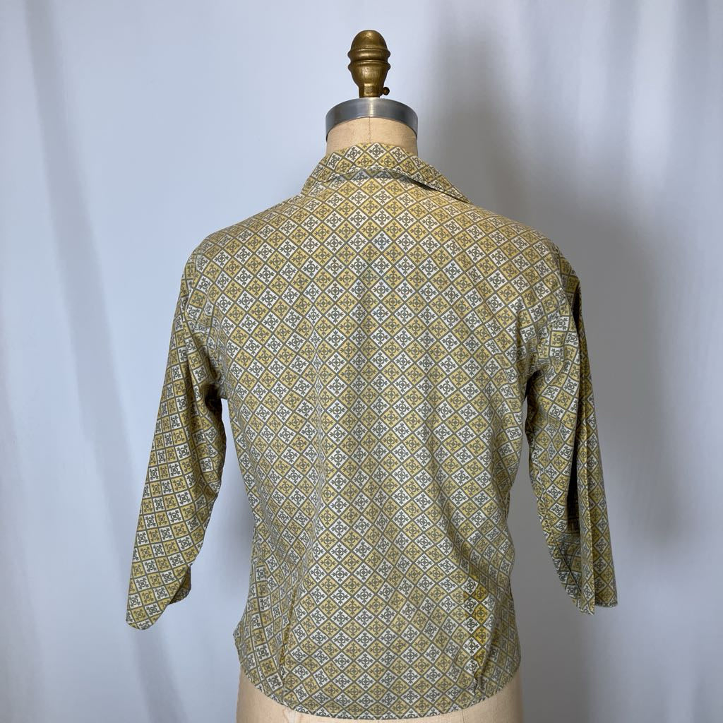 Green patterned shirt on a mannequin against a white background