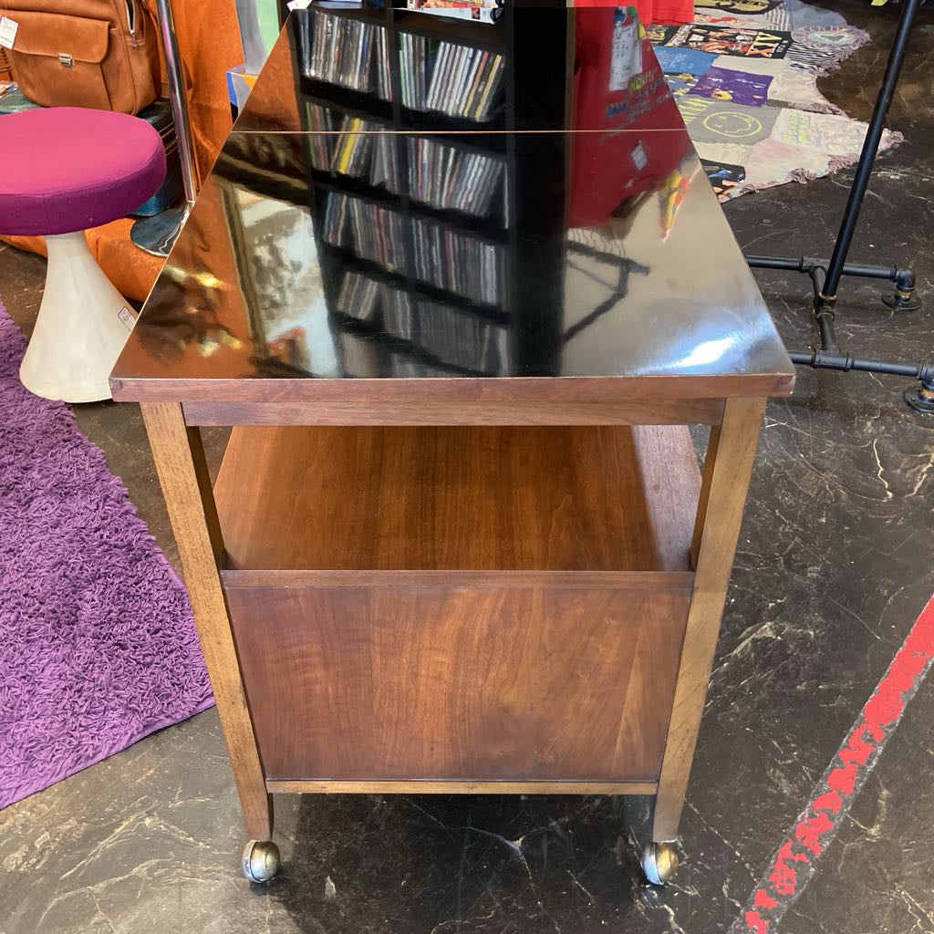 Wooden cart with glass top in a store setting