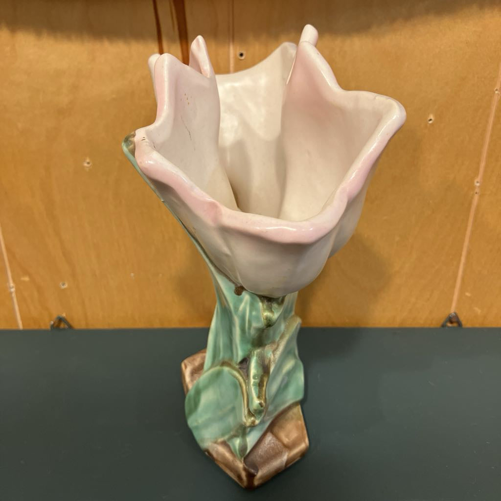 Ceramic vase shaped like a flower with a brown background