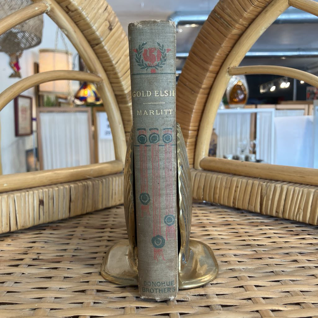 Vintage book on a decorative stand with a wicker background
