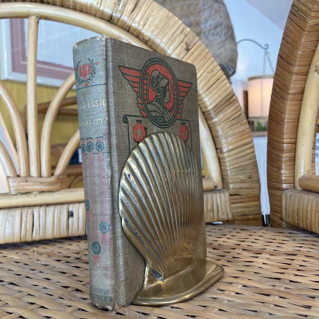 Vintage book with a shell design on a wicker surface