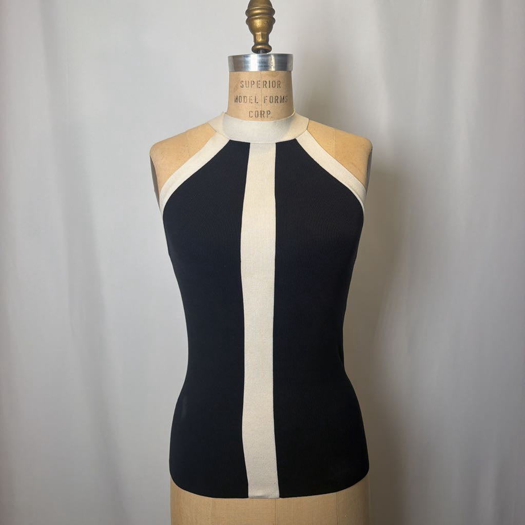 Black and white sleeveless top on a mannequin against a plain background