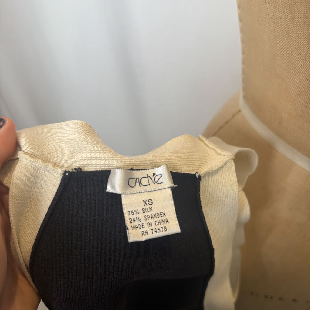 Black garment with a visible brand label on a neutral background