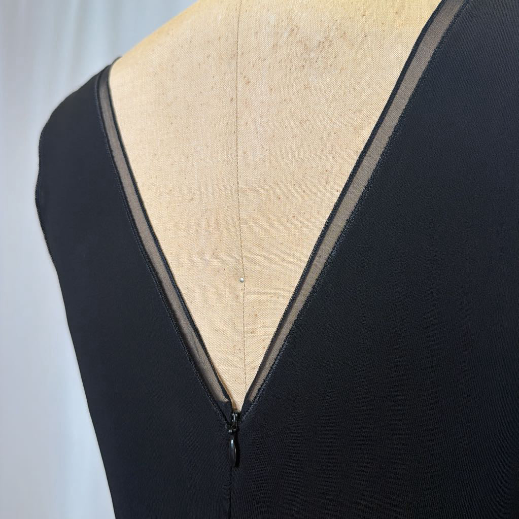 Black garment with beige lining on a white background