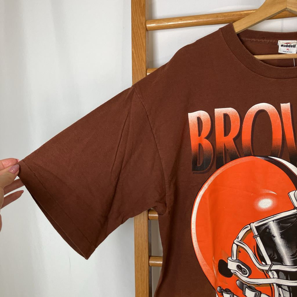 Brown t-shirt with football helmet graphic and 'BROWNS' text on a hanger.