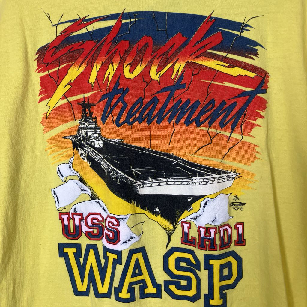 T-shirt with a graphic of USS LHD1 WASP and text on a yellow background