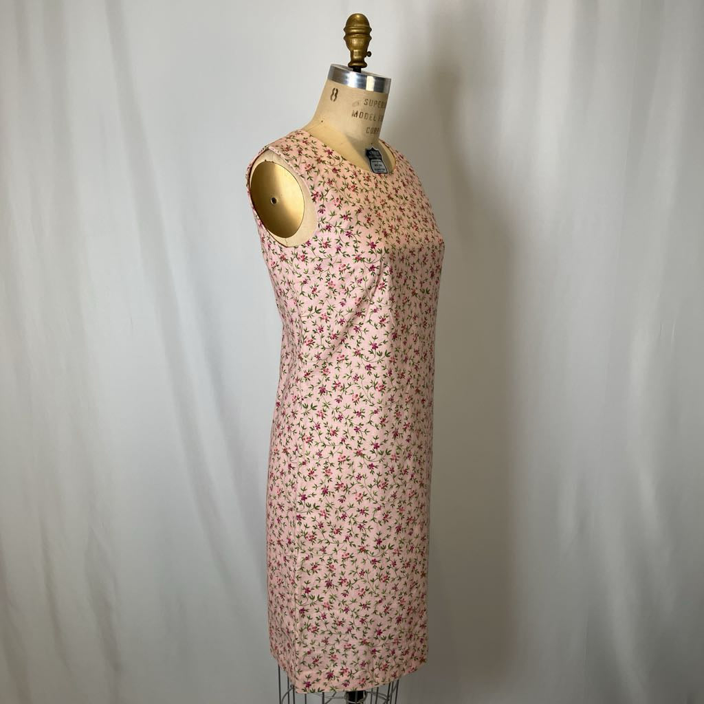 Floral dress on a mannequin against a plain background