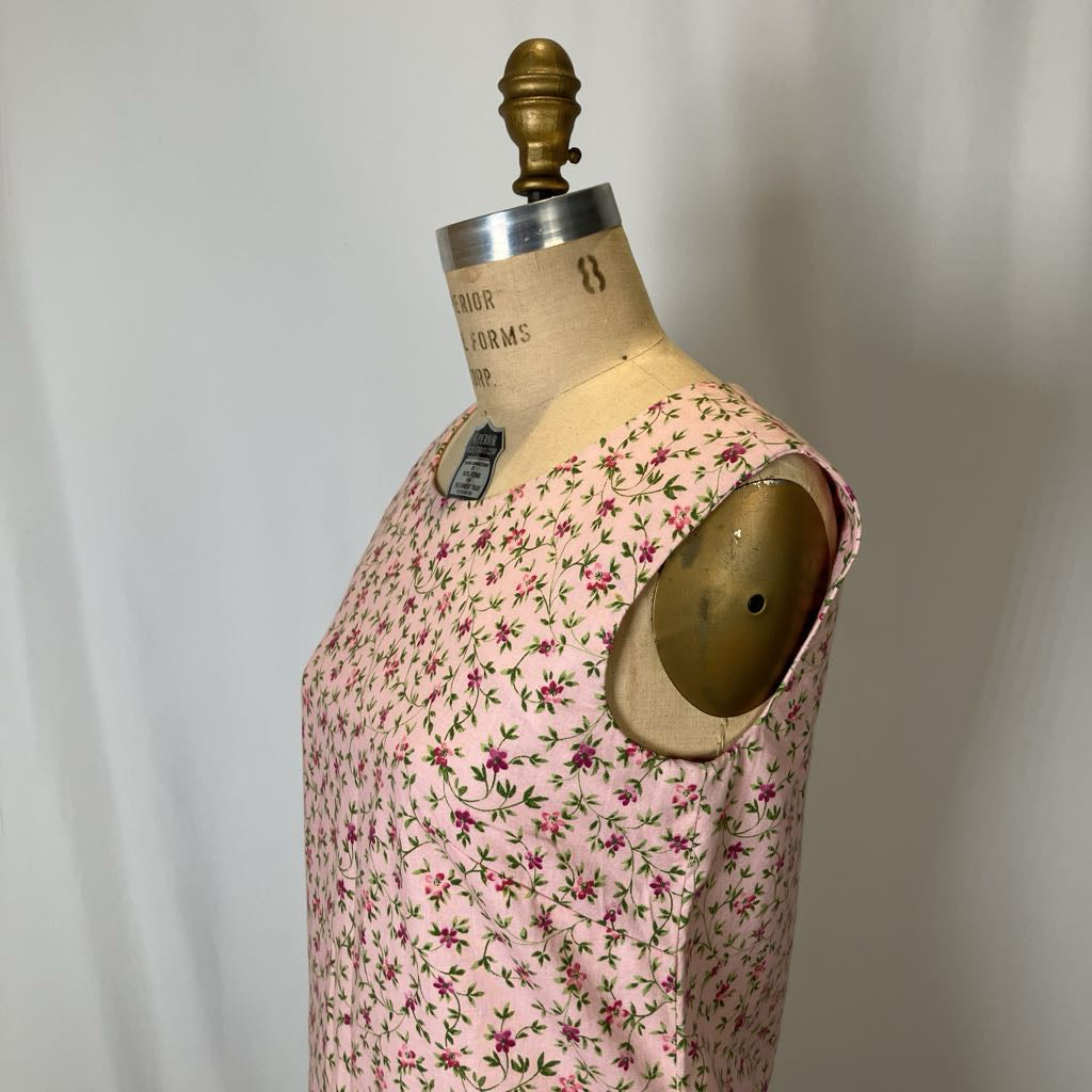 Mannequin wearing a pink floral dress against a plain background