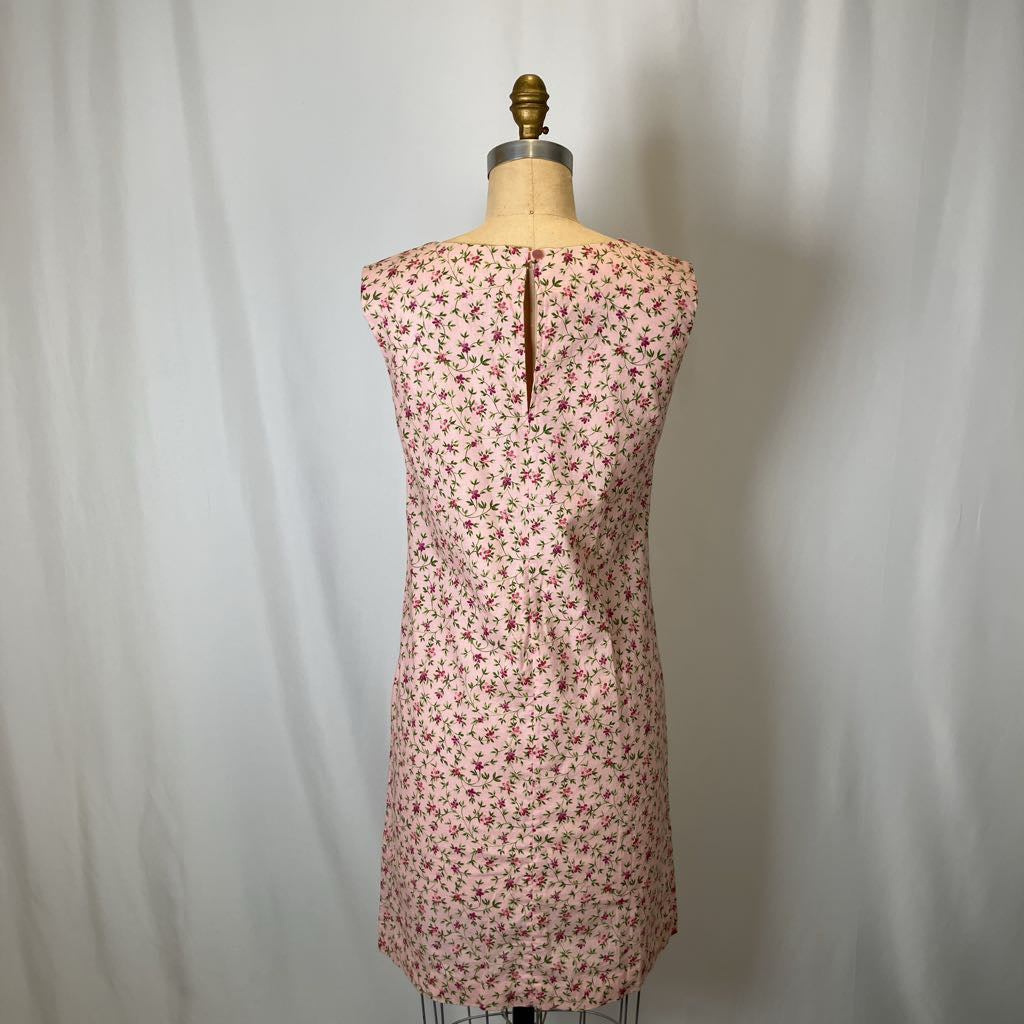 Floral dress on a mannequin against a plain background