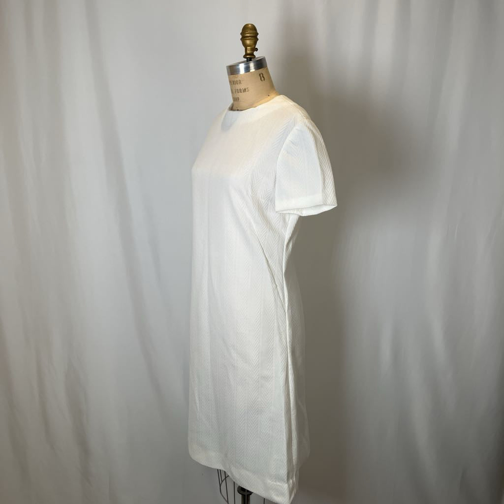 White t-shirt on a mannequin against a plain background