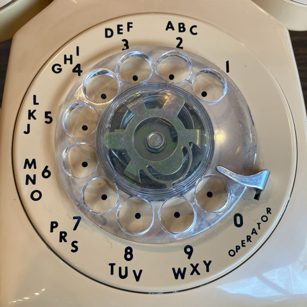 Close-up of a vintage rotary phone dial with clear center