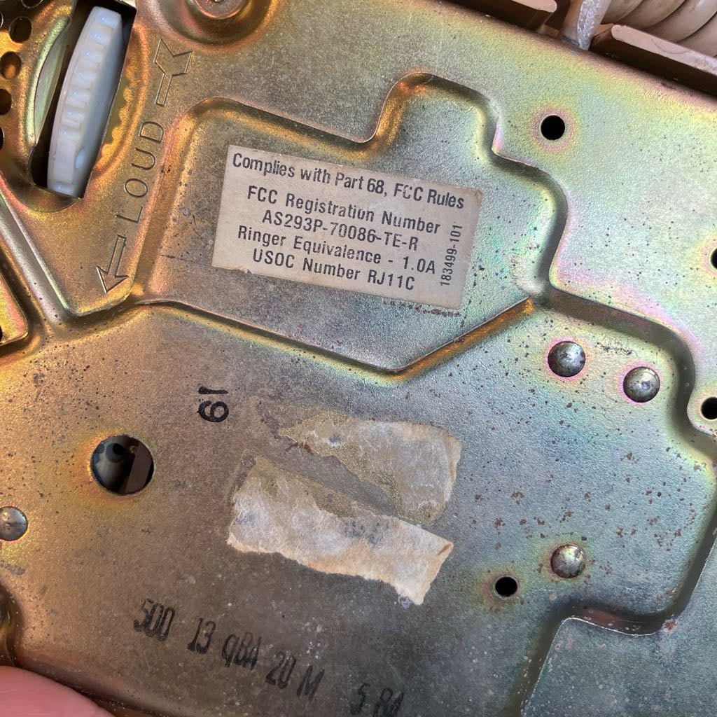 Metallic device with FCC registration label and text