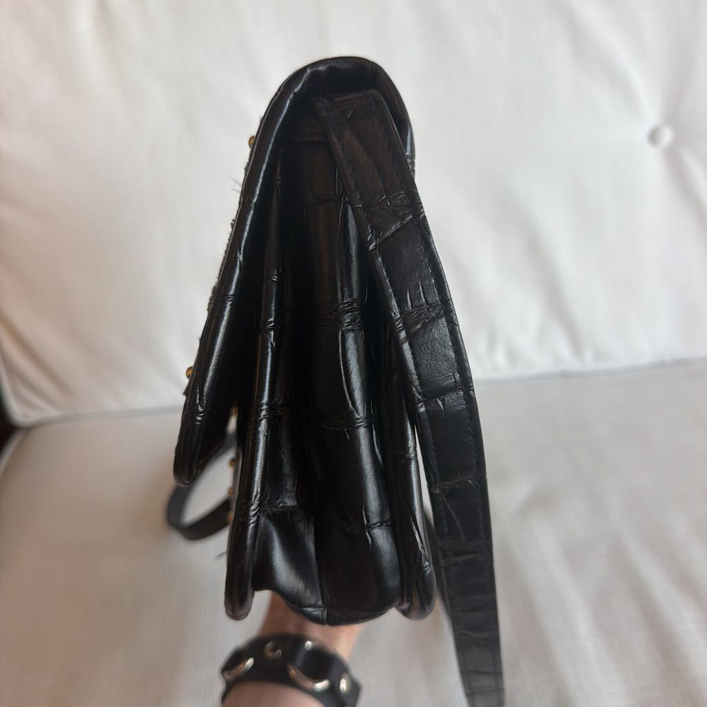 Black leather clutch bag on a white background