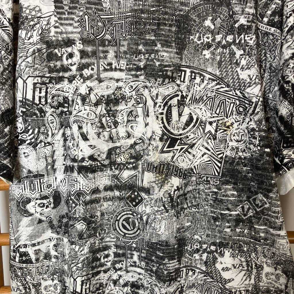Black and white patterned fabric with various designs and text.