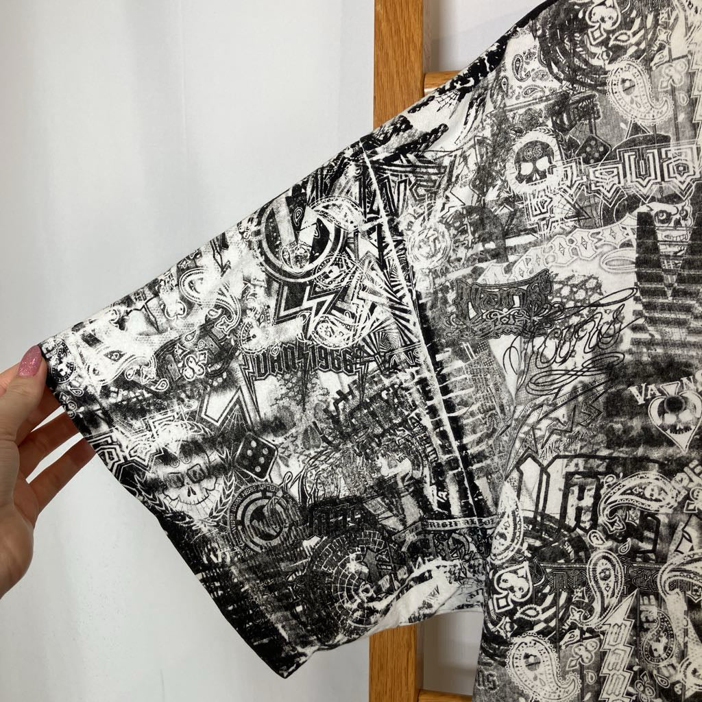 Two black and white patterned fabric swatches held by a hand against a white background.