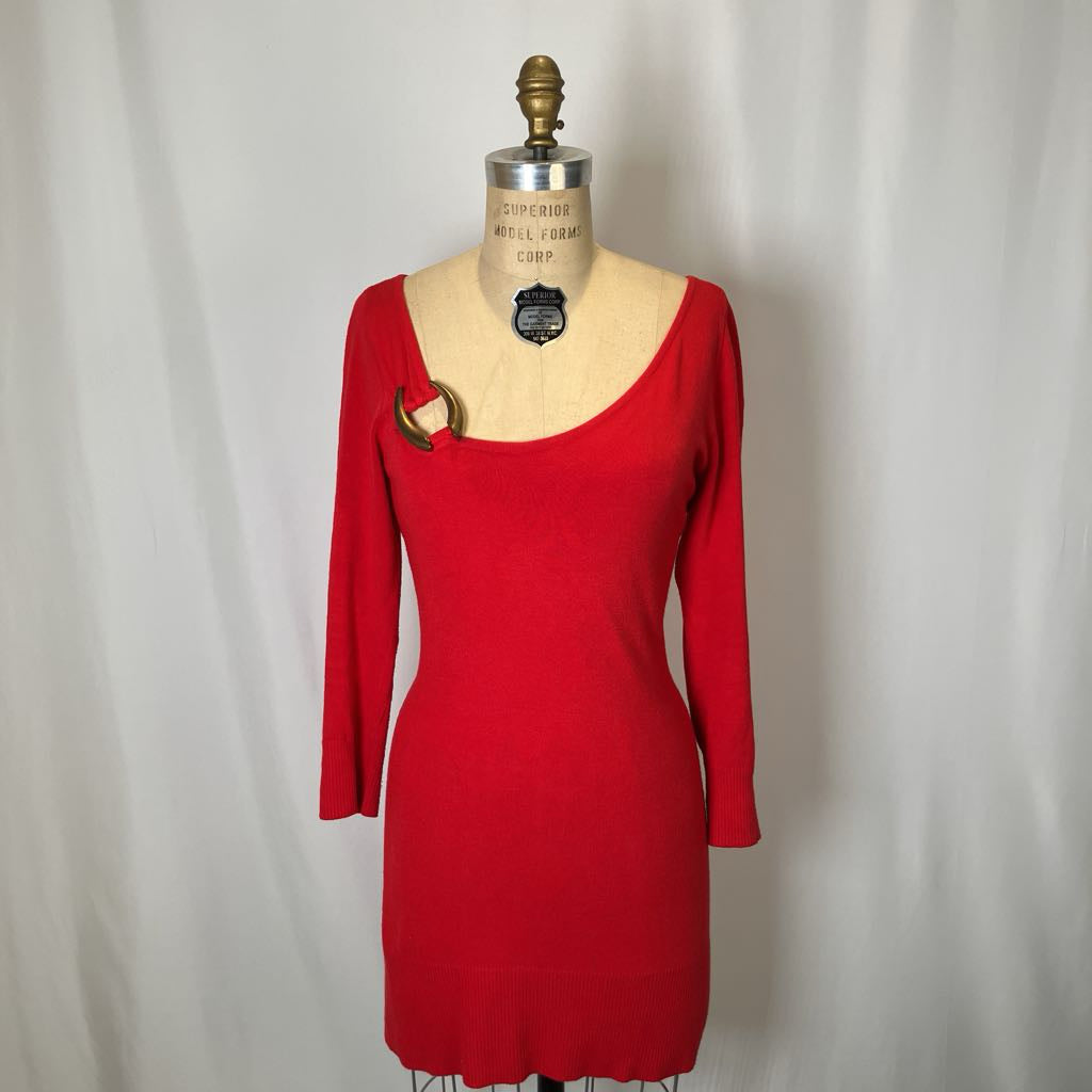 Red dress on a mannequin against a plain background