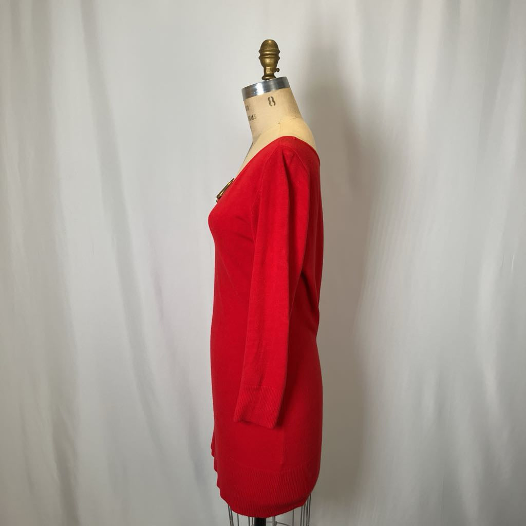 Red dress on a mannequin against a plain background