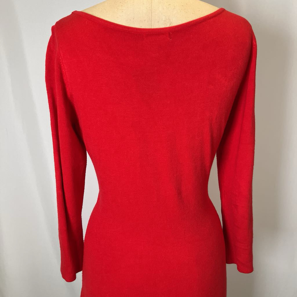 Red long-sleeve dress on a mannequin against a plain background
