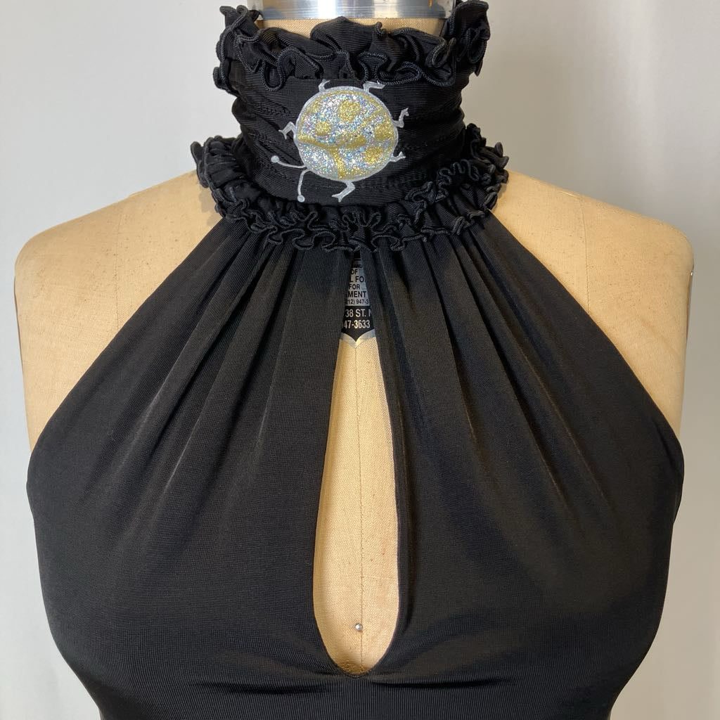 Black halter top with ruffled neckline on a mannequin against a neutral background