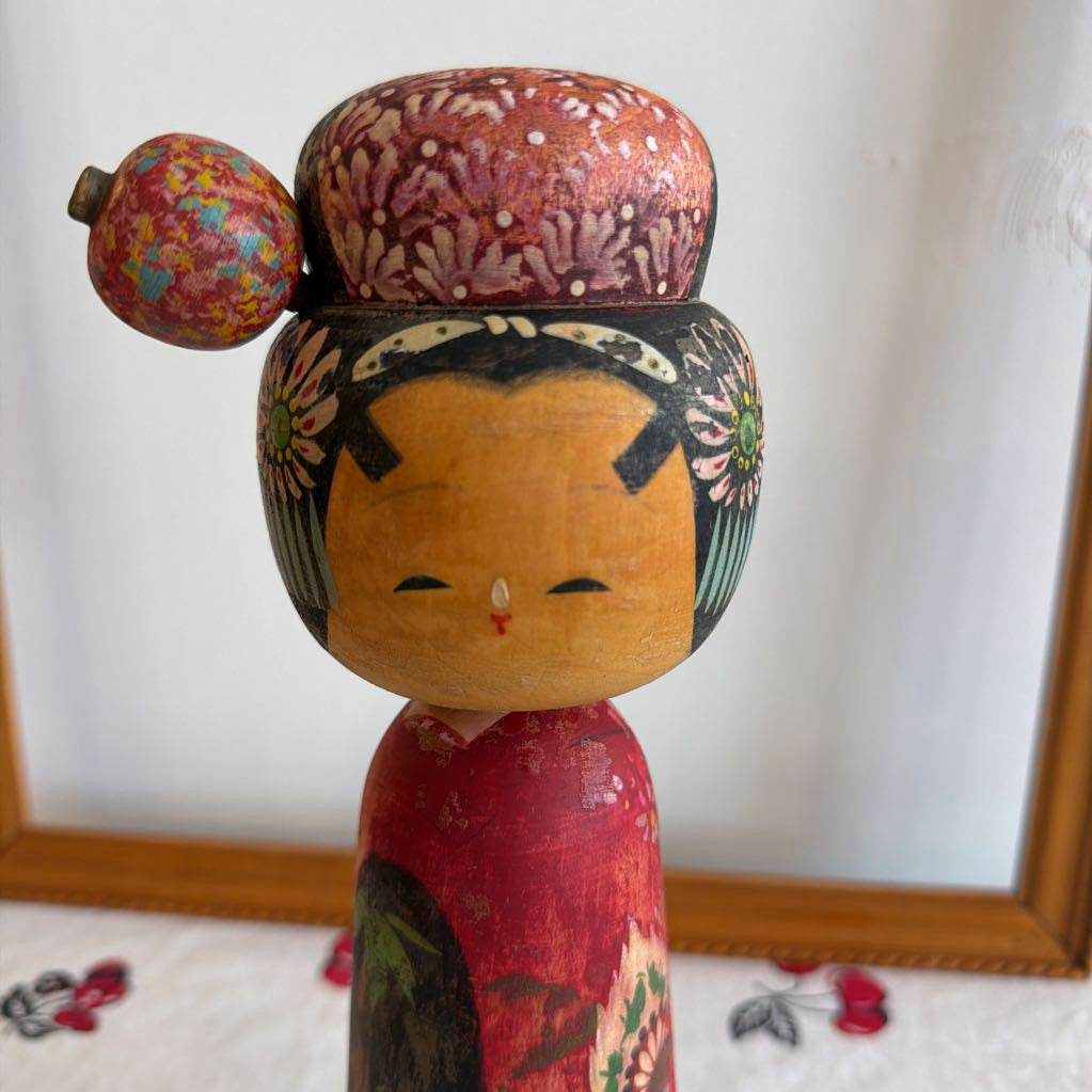 Up close of face of Vintage Kokeshi doll made of wood and her head moves