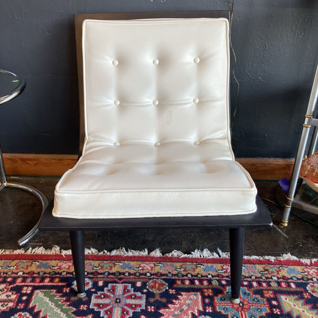 White mcm tufted vinyl scoop chair with walnut wood frame  that has been painted black 