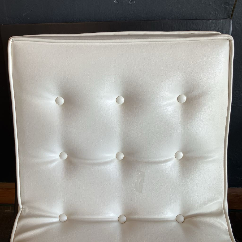 White mcm tufted vinyl scoop chair with walnut wood frame  that has been painted black 