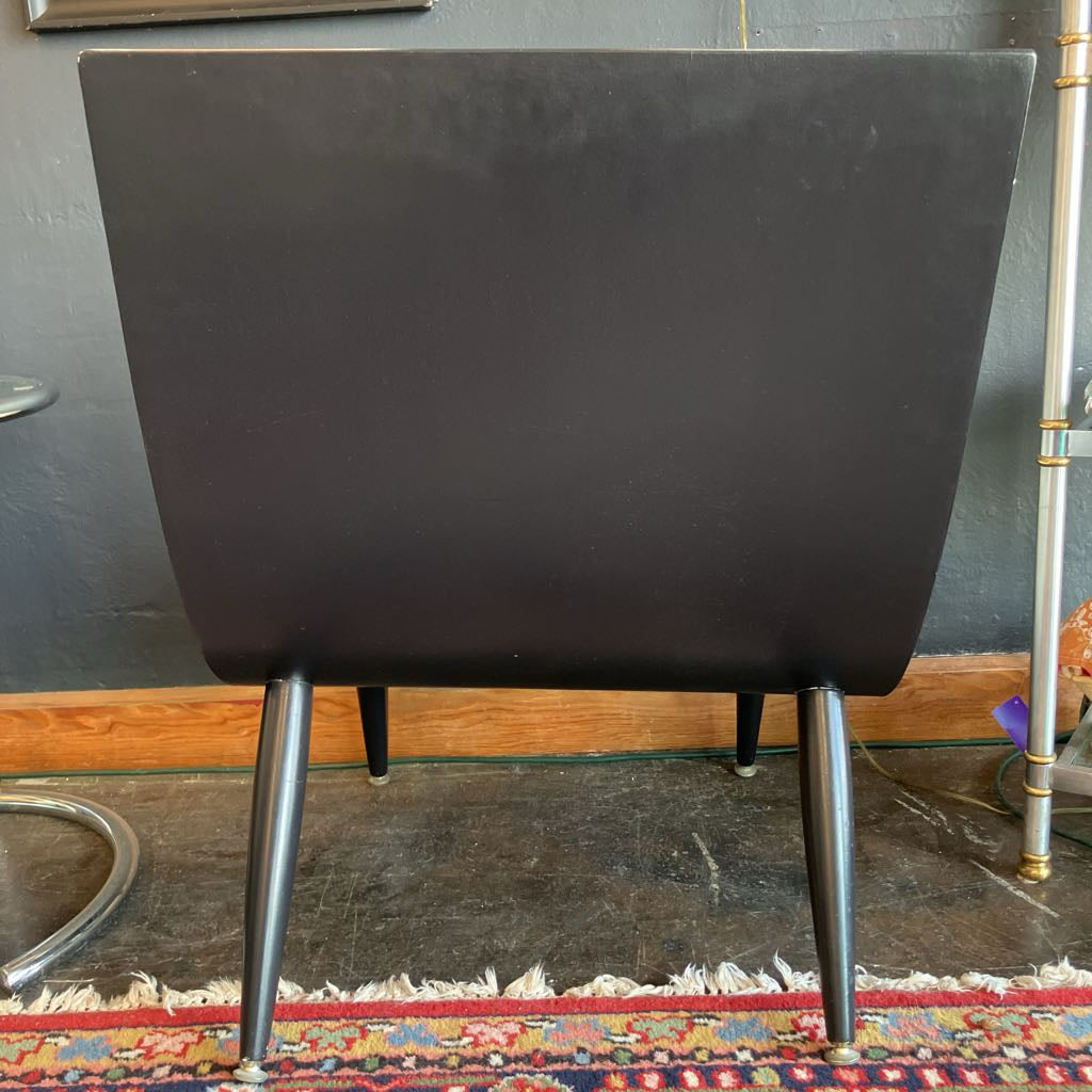 Back of the white mcm tufted vinyl scoop chair with walnut wood frame  that has been painted black 