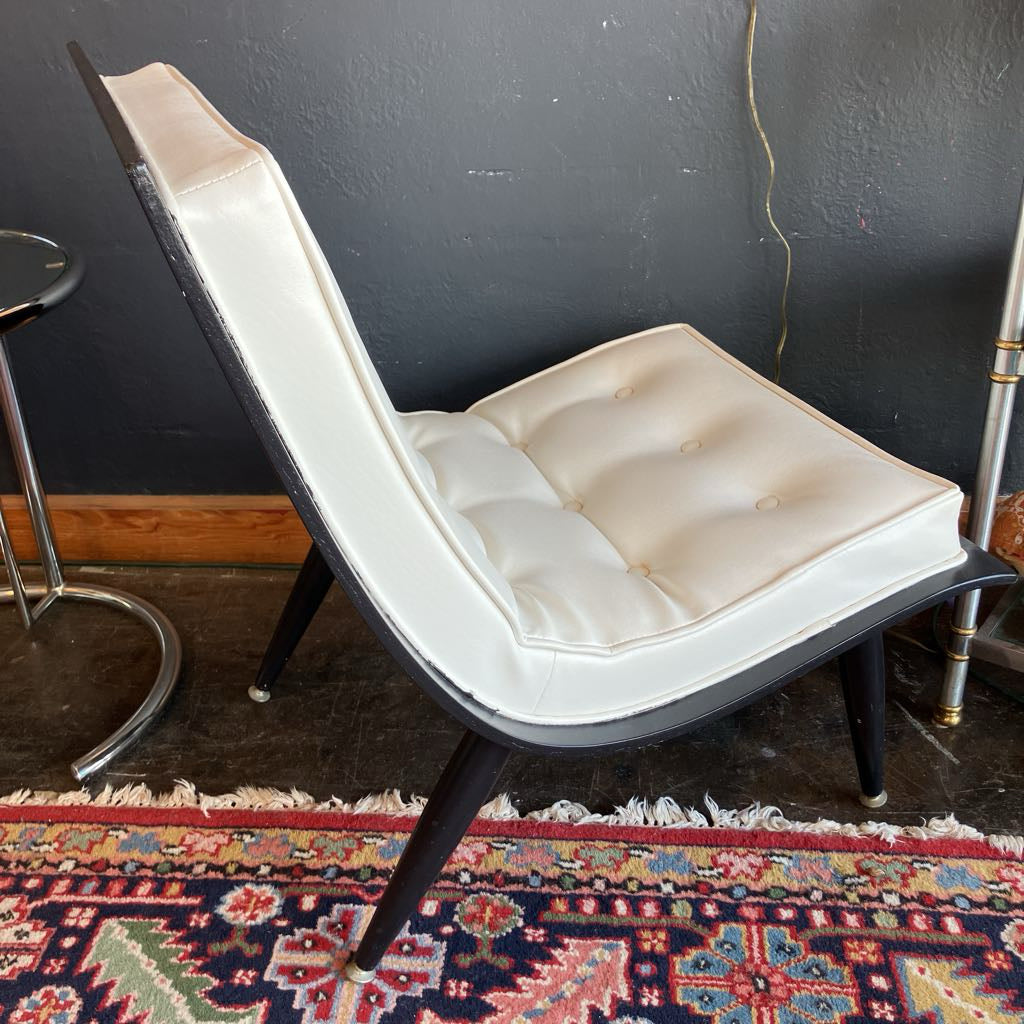 Side view of white mcm tufted vinyl scoop chair with walnut wood frame  that has been painted black 