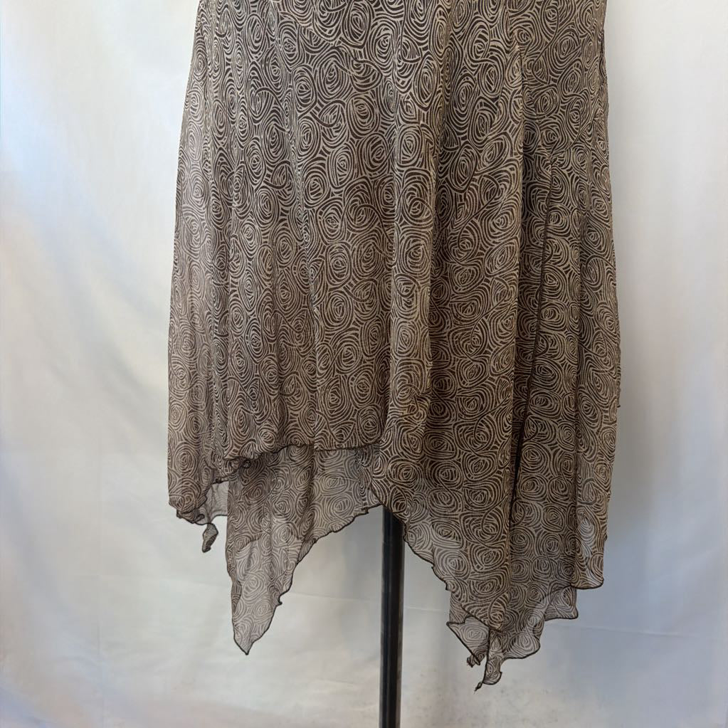A sheer, lightweight brown tunic or cover-up with an intricate swirling floral pattern, displayed on a black stand against a white fabric backdrop.
