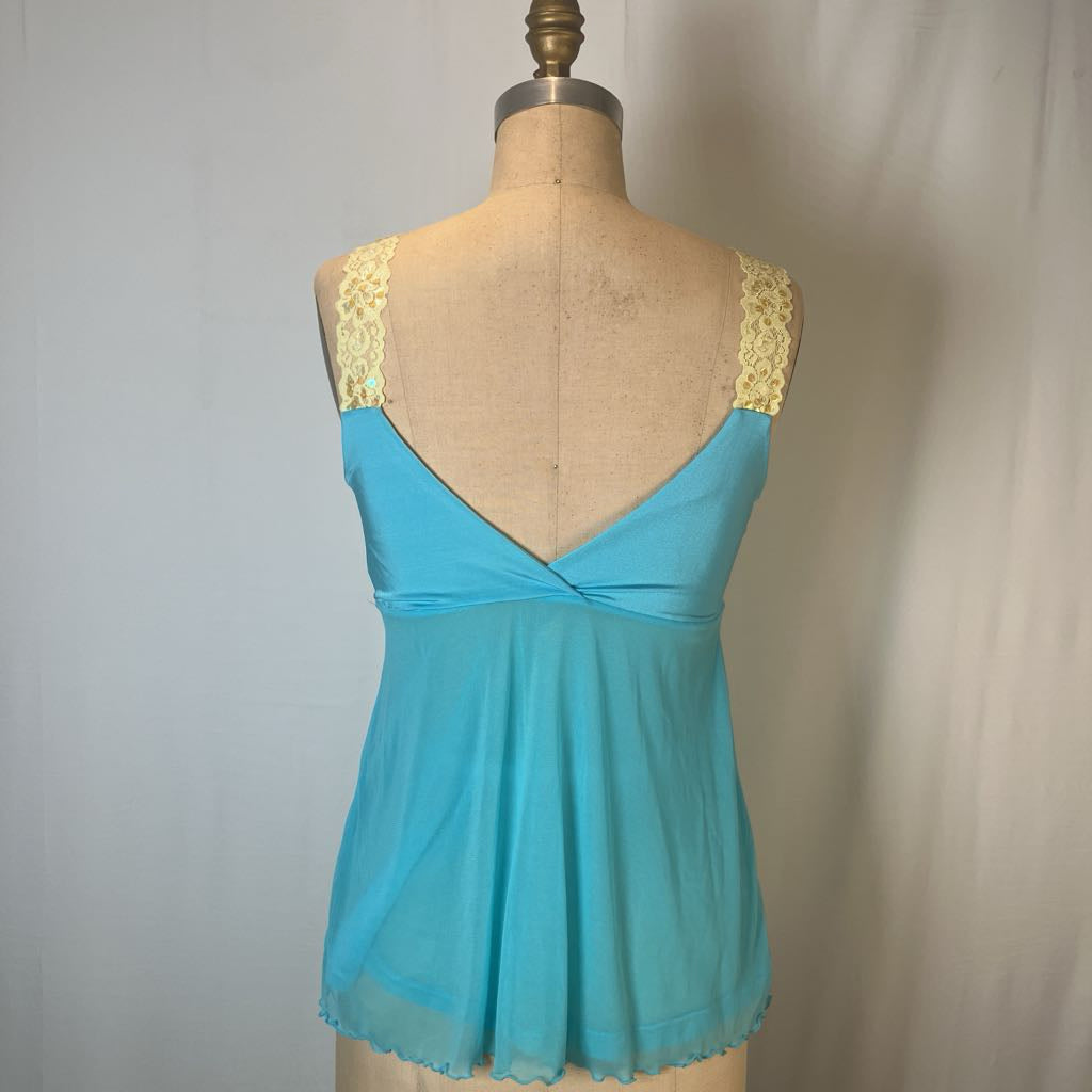 A turquoise blue camisole top displayed on a tan dress form mannequin, featuring yellow lace shoulder straps and a twisted crossover neckline.