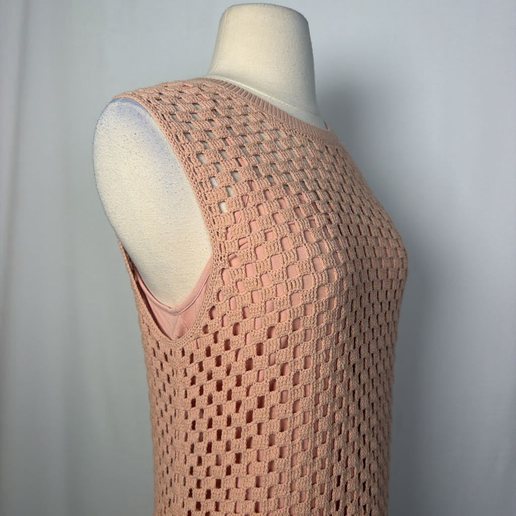 A sleeveless open-knit crochet top in a dusty pink color, displayed on a cream-colored mannequin torso against a light gray background.
