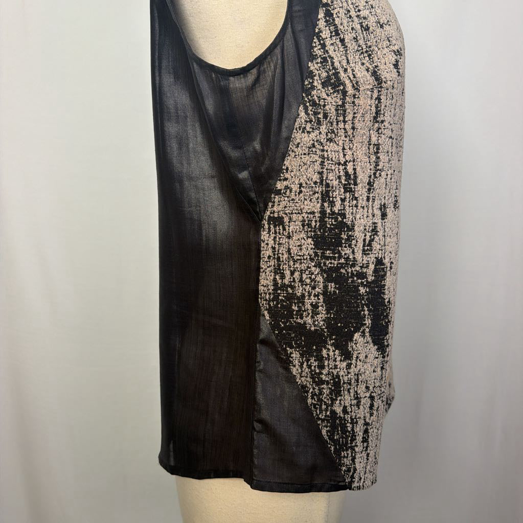 A sleeveless black sheer mesh top with a distressed black and beige patterned panel, displayed on a mannequin torso against a light gray background.