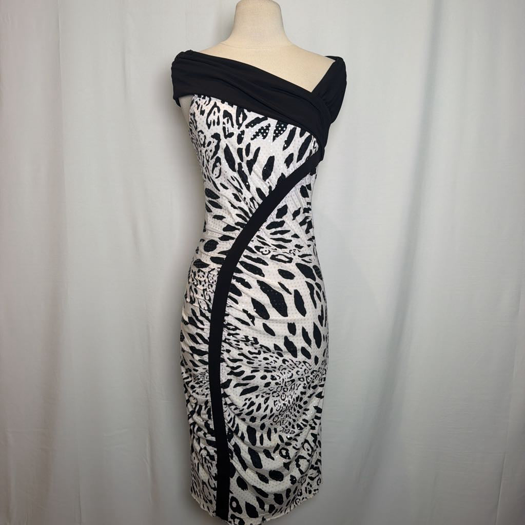 A black and white patterned off-the-shoulder bodycon dress displayed on a mannequin torso against a white fabric backdrop.