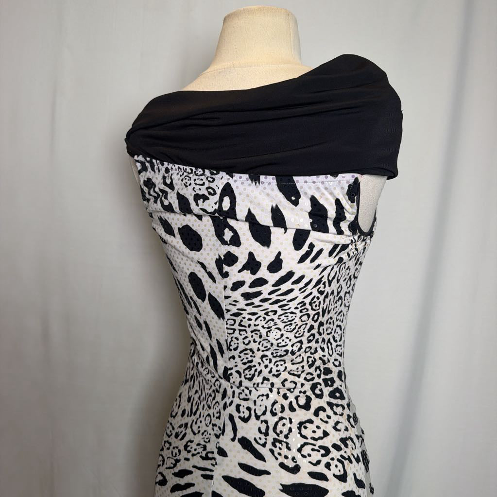 A black and white leopard print dress displayed on a cream mannequin torso against a light gray fabric backdrop.