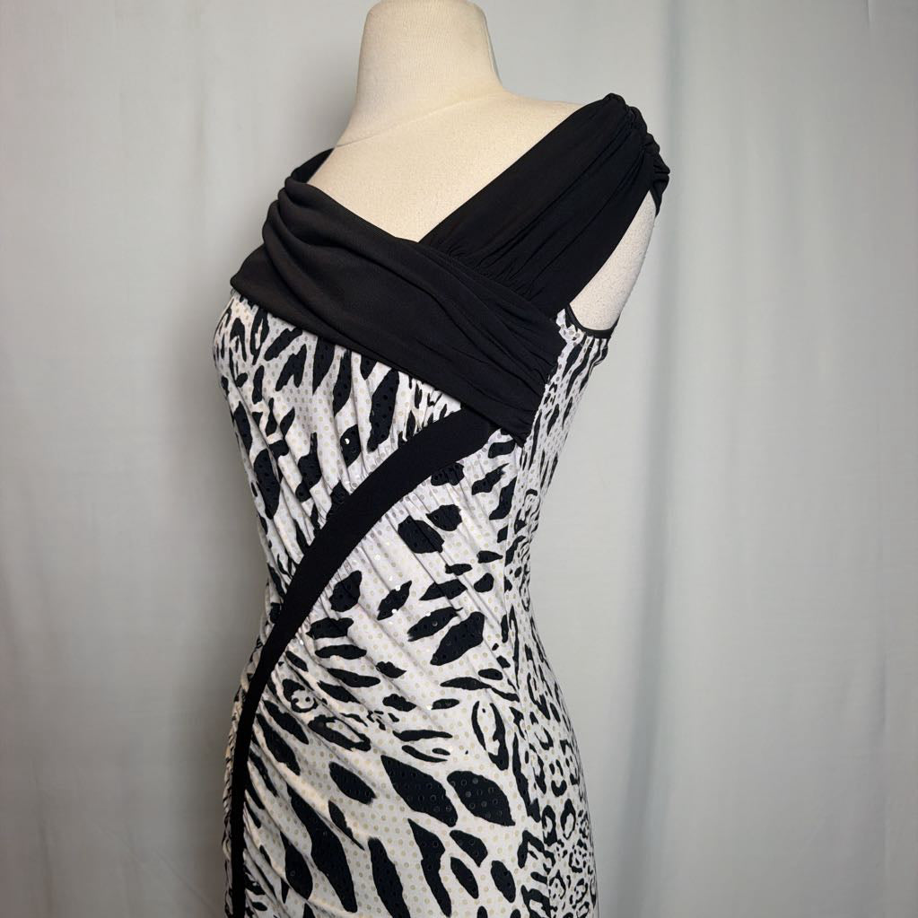A black and white patterned dress displayed on a mannequin torso against a light gray fabric backdrop.