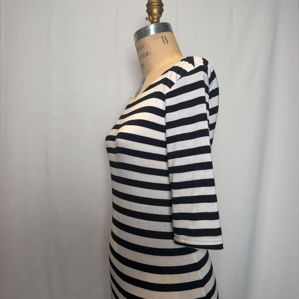 A black and white horizontally striped short-sleeve dress displayed on a vintage dress form mannequin against a white fabric backdrop.