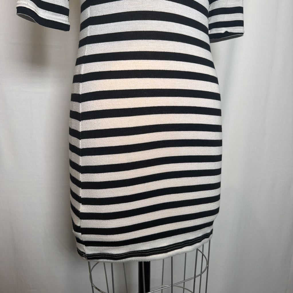 A short-sleeve knit dress with horizontal black and off-white stripes, displayed on a wire dress form against a white fabric backdrop.