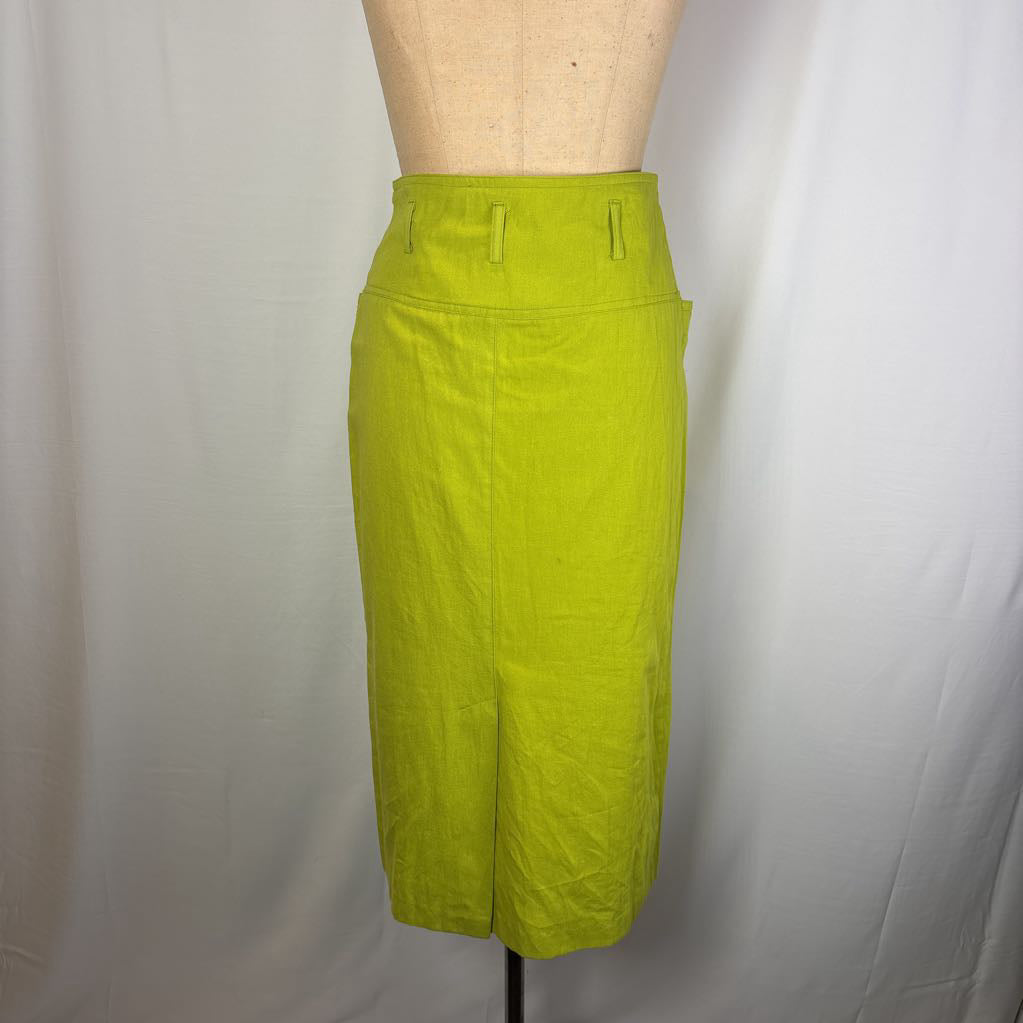 A bright lime green high-waisted pencil skirt displayed on a beige dress form mannequin against a white fabric backdrop.