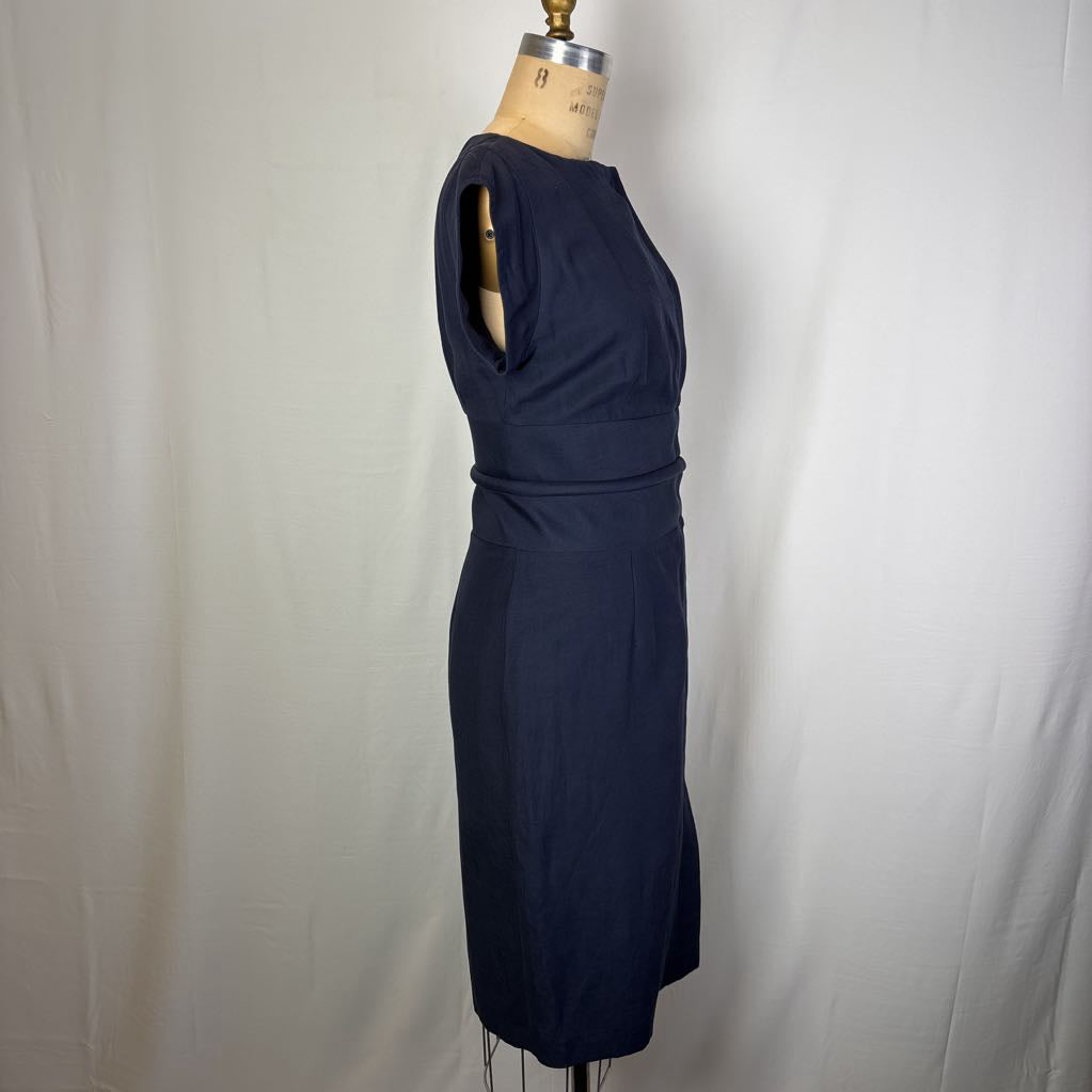 A navy blue sleeveless sheath dress displayed on a dress form mannequin against a white fabric backdrop.