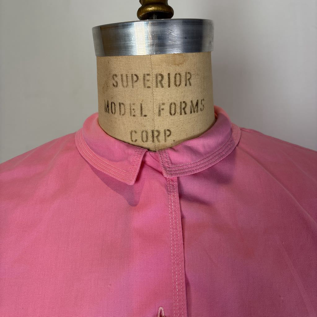 A pink collared shirt or blouse displayed on a vintage mannequin torso. The mannequin neck label reads 'SUPERIOR MODEL FORMS CORP.