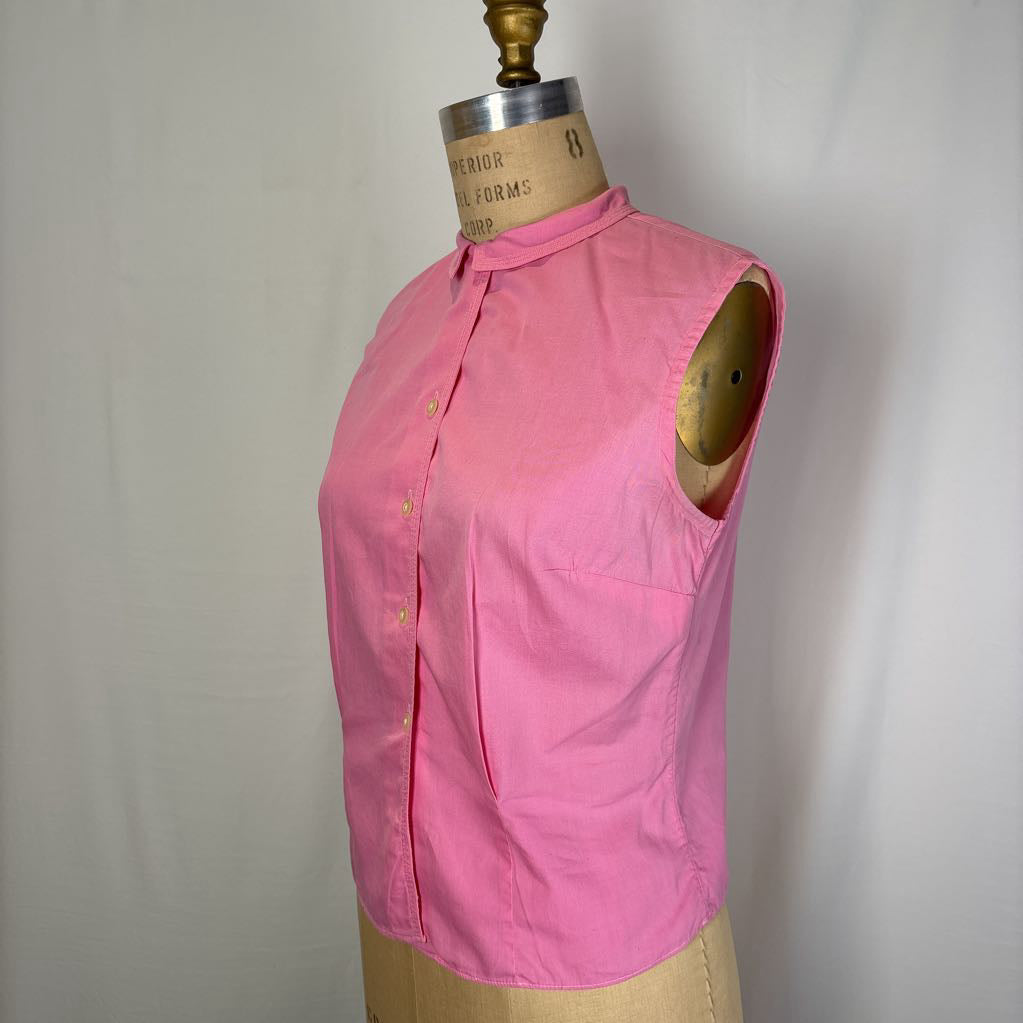 A pink sleeveless button-front top displayed on a dress form mannequin against a plain light background.