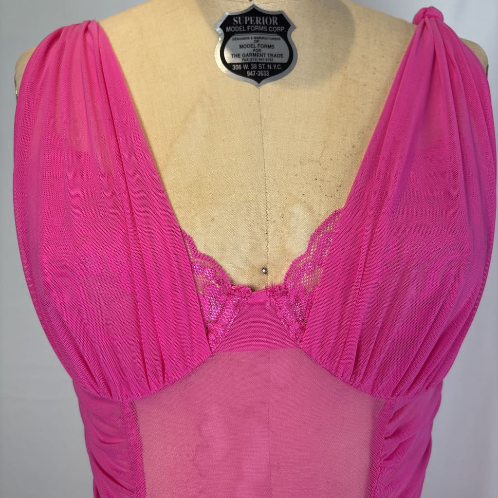 A bright pink sheer lingerie chemise with gathered draping sleeves and a lace-trimmed plunging neckline, displayed on a tan dress form. A black 'SUPERIOR' brand label is pinned at the neck.