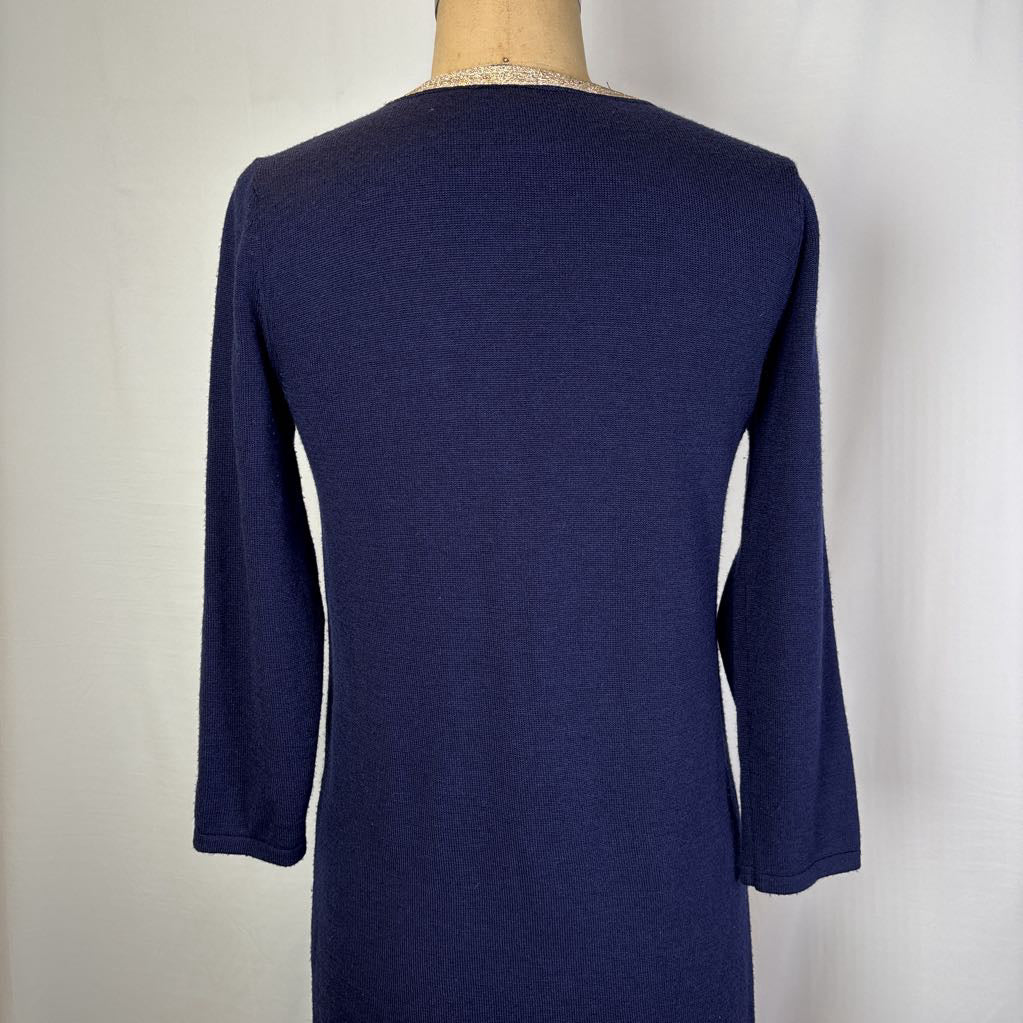 A navy blue long-sleeve knit top displayed on a dress form mannequin, viewed from the back against a plain white background.