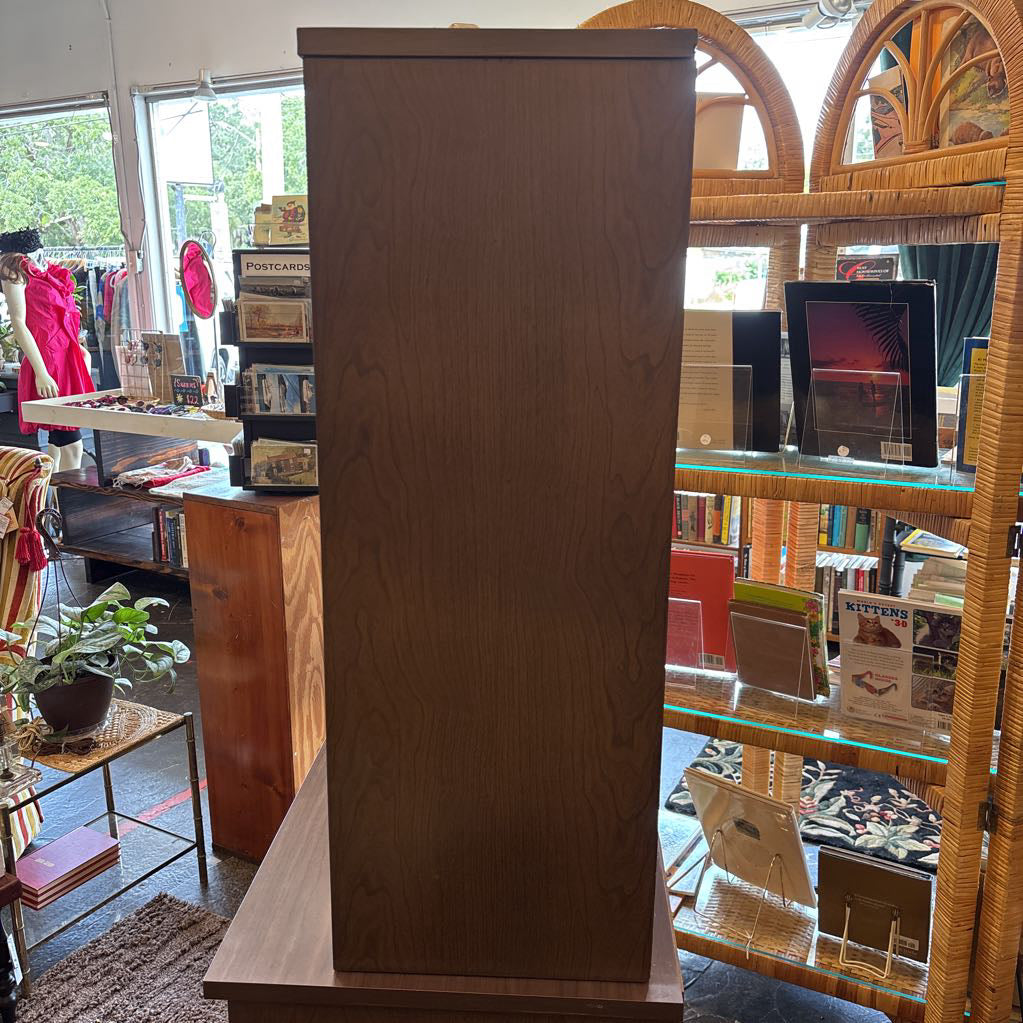 The side of a large wooden hutch in a store setting. 
