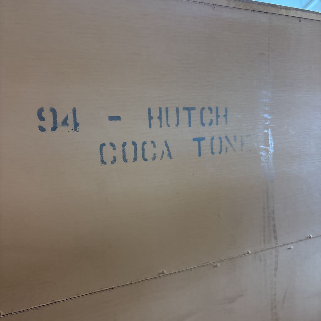 The back of a wooden hutch with the words '94 - Hutch Coca Tone' written on the back.