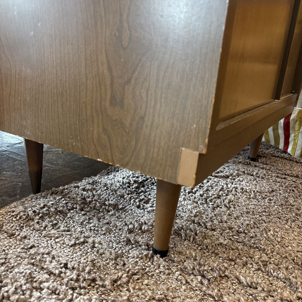 The side of a large wooden hutch in a store setting. 