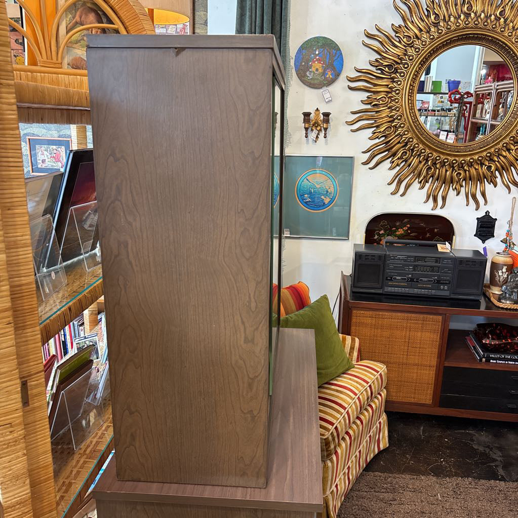 The side of a large wooden hutch in a store setting. 